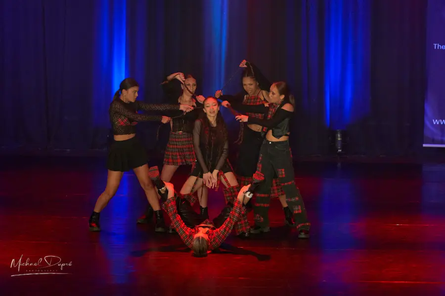 Commercial dance group on the Conquer stage